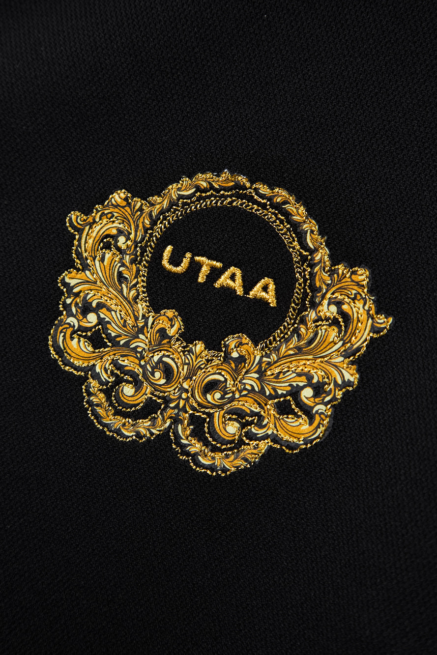 UTAA クレストゴールデンエンブレムPK Tシャツ ブラック：レディース